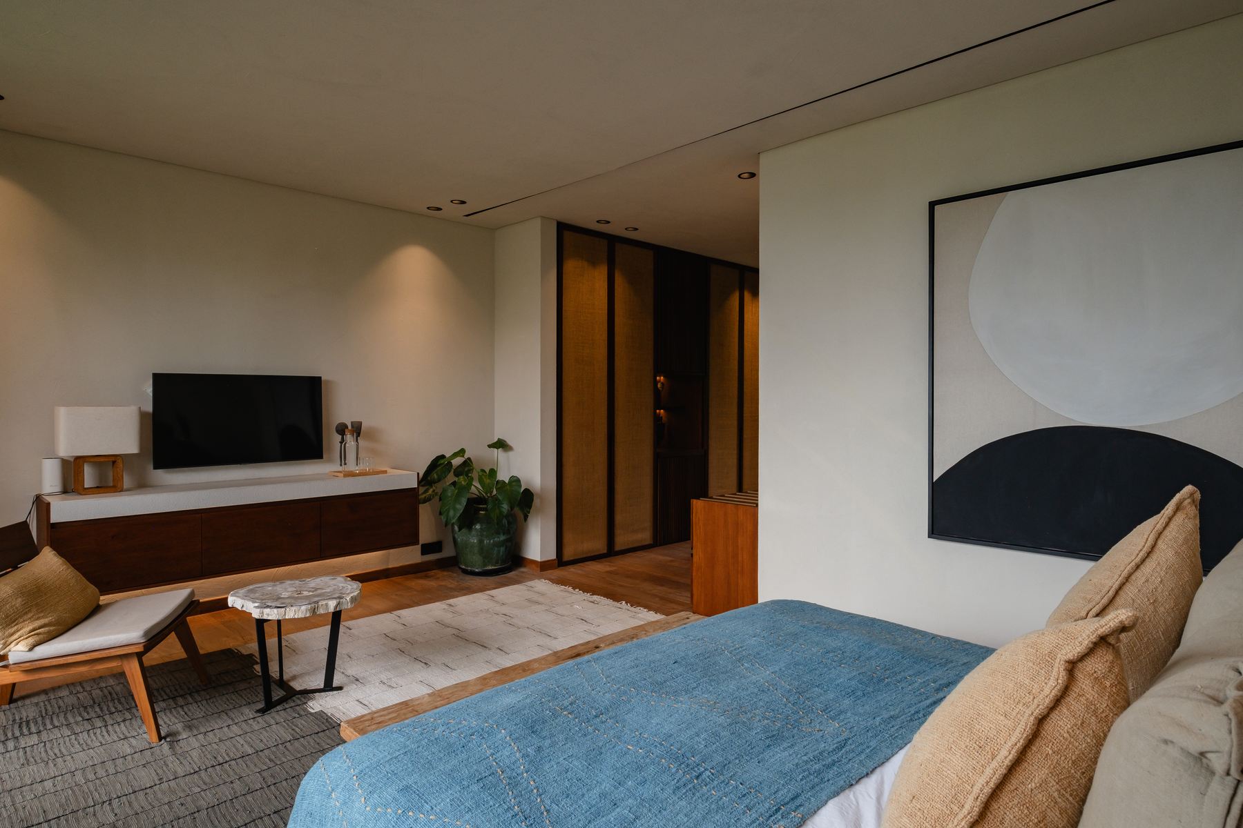 Bedroom with television and artwork